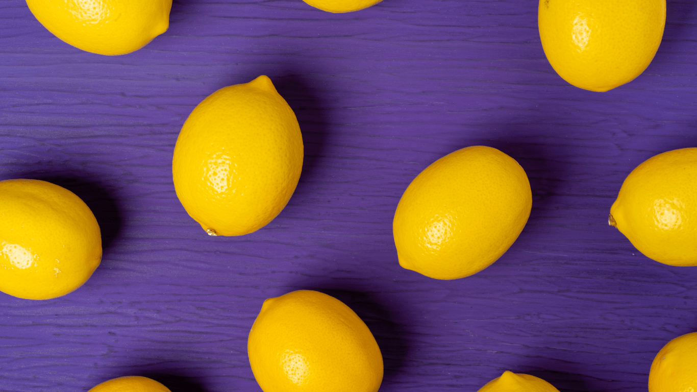 Top view of lemon on purple wooden background for blog called "don't get left behind 6 reasons why you should be taking advantage of social media"